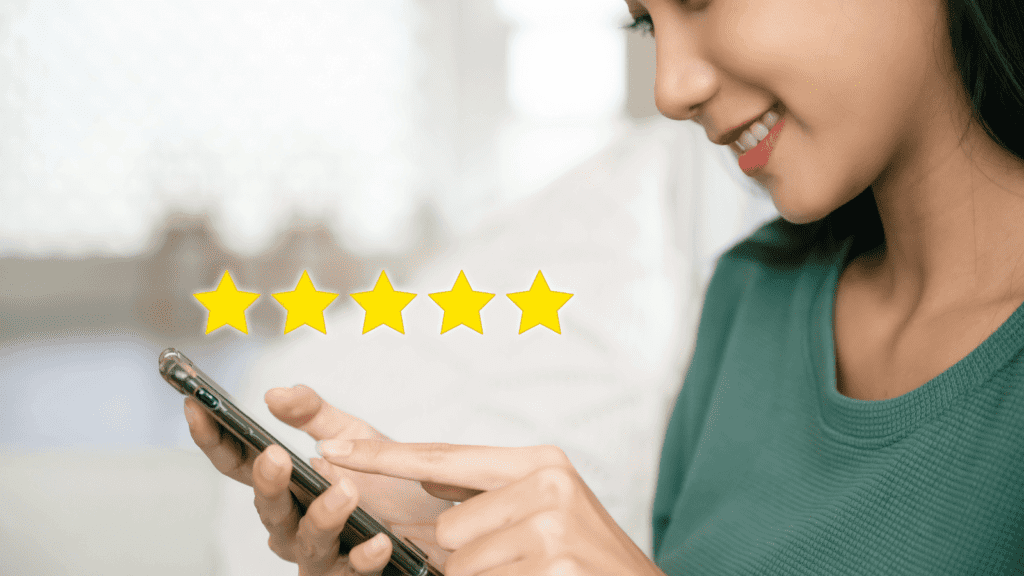 A lady on her mobile phone writing a 5 star customer review